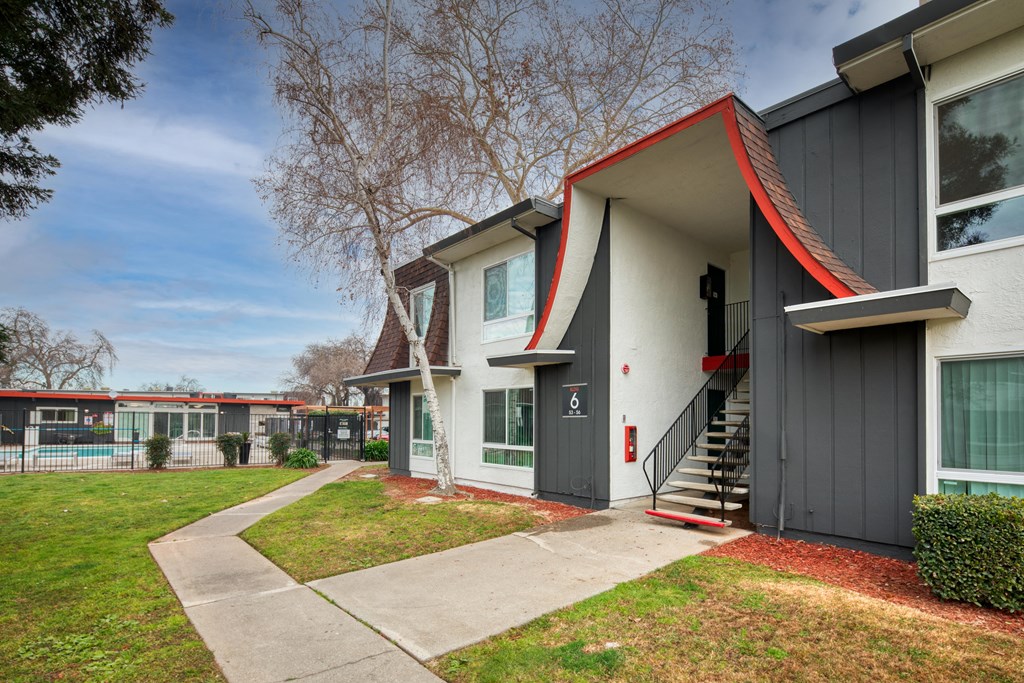 a view of the exterior of a building at the whispering winds apartments in pearland, tx