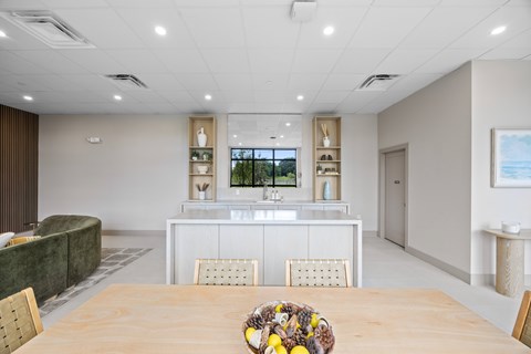 A dining room with a wooden table and chairs.