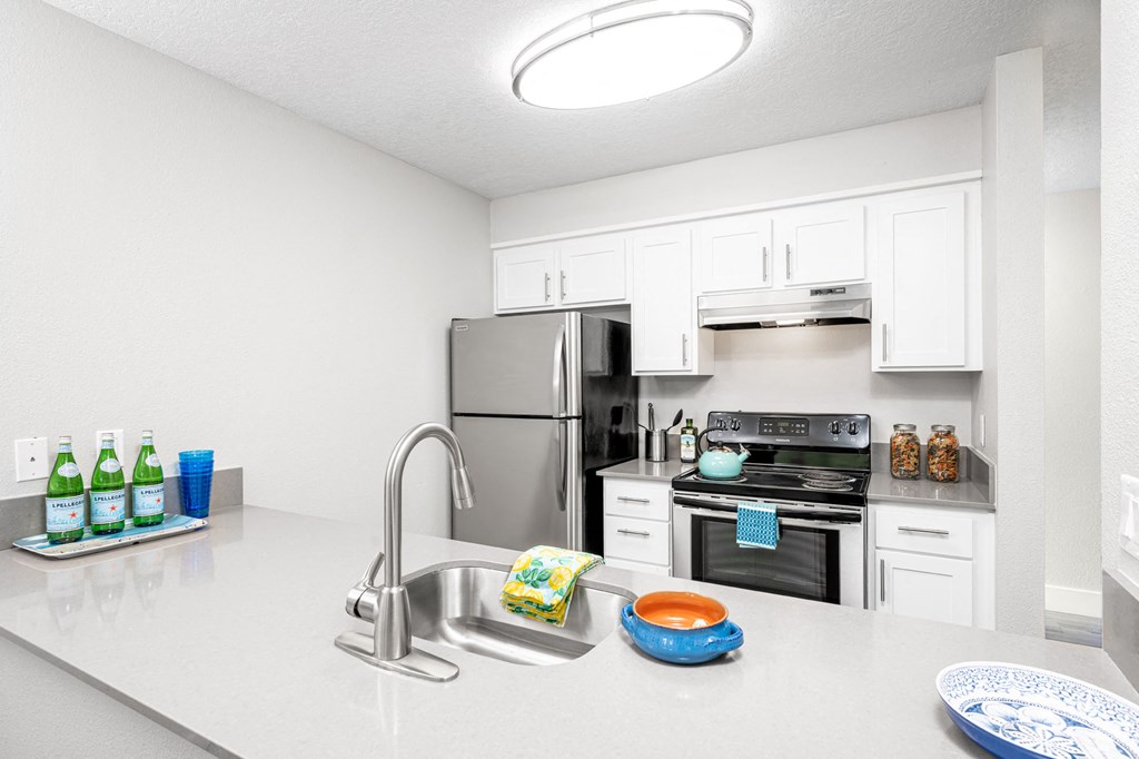 a kitchen with white cabinetry and stainless steel appliances