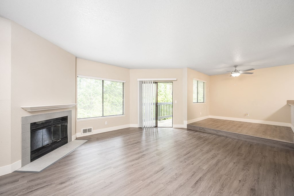 a living room with hardwood floors and a fireplace