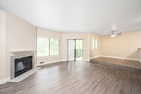 a living room with hardwood floors and a fireplace