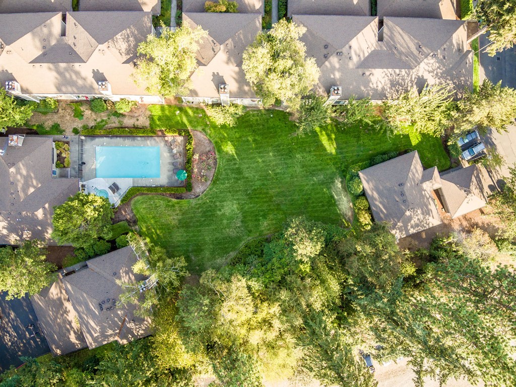 a birdseye view of a house with a large backyard