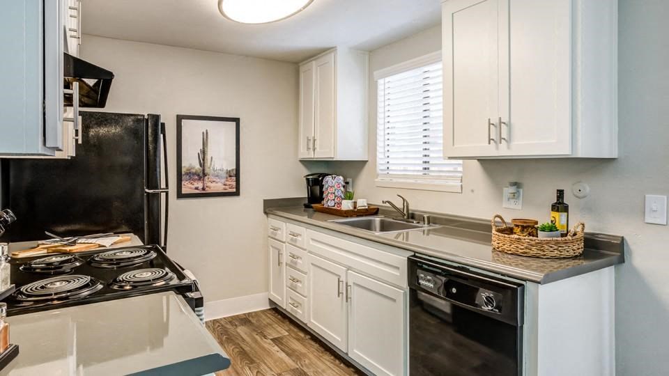 a kitchen with a stove top oven next to a sink
