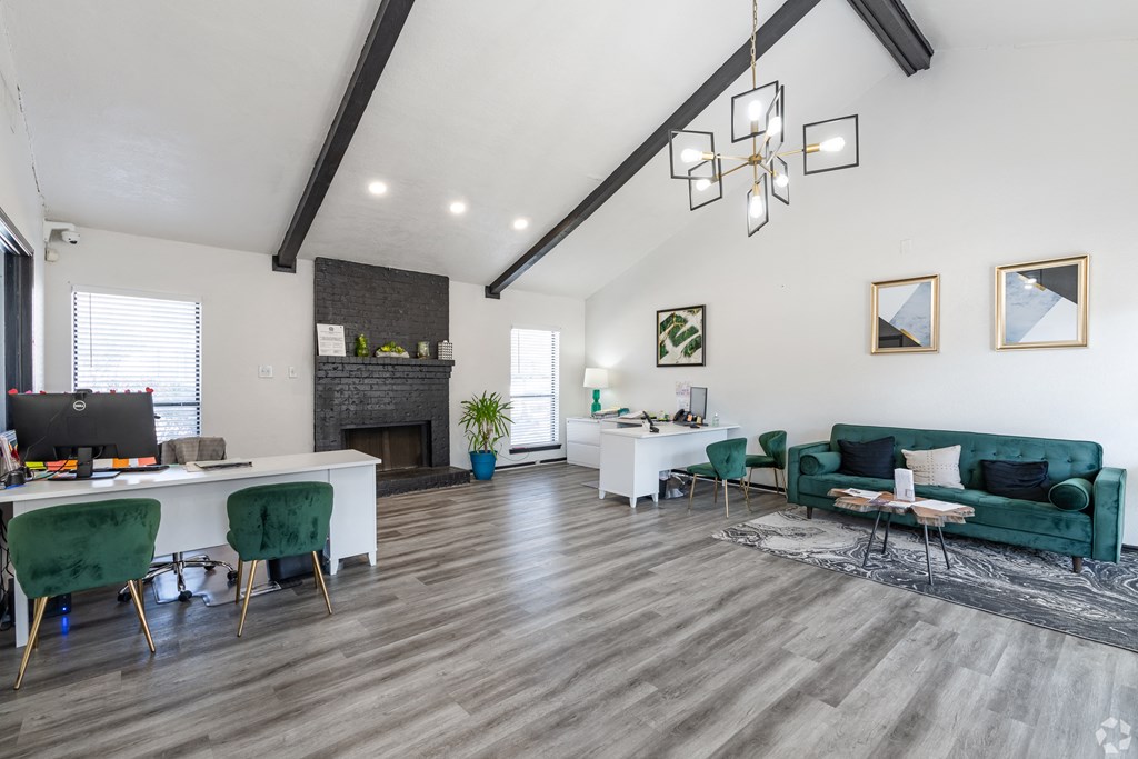 A modern living room with a green couch and a fireplace.