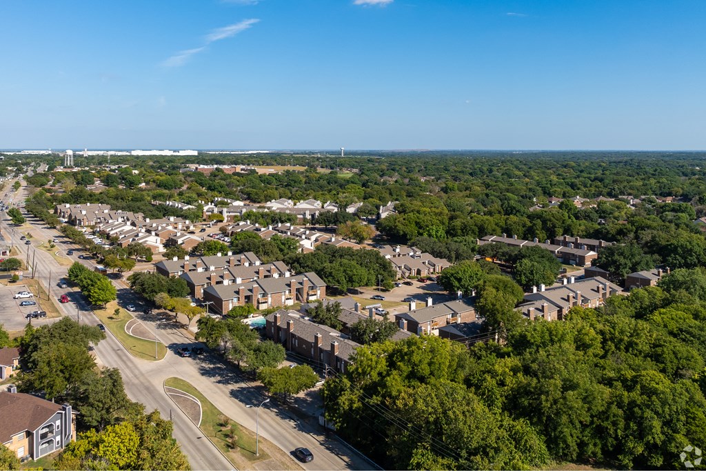 A suburban area with a road and houses.