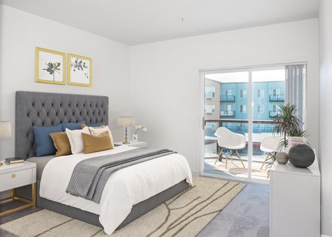 a bedroom with a bed and a door to a patio