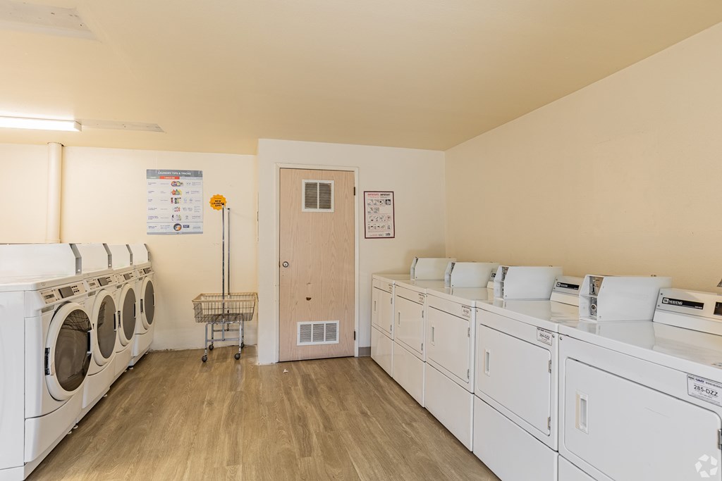 A laundry room with washers and dryers.