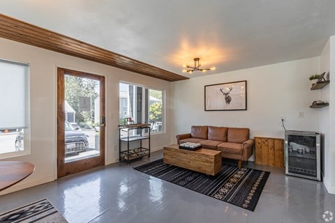 A living room with a brown couch and a fireplace.
