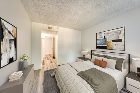 a bedroom with a large bed and two night stands with lamps