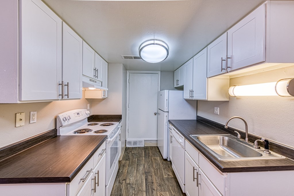 a kitchen with white cabinets and white appliances