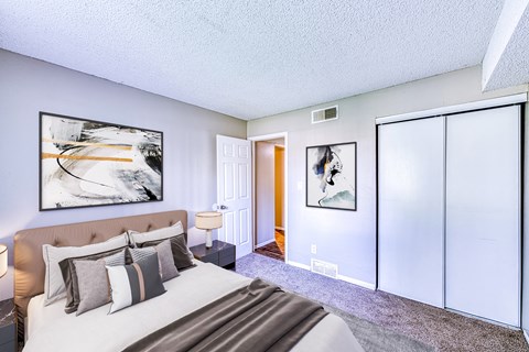 a bedroom with a large bed and sliding glass doors