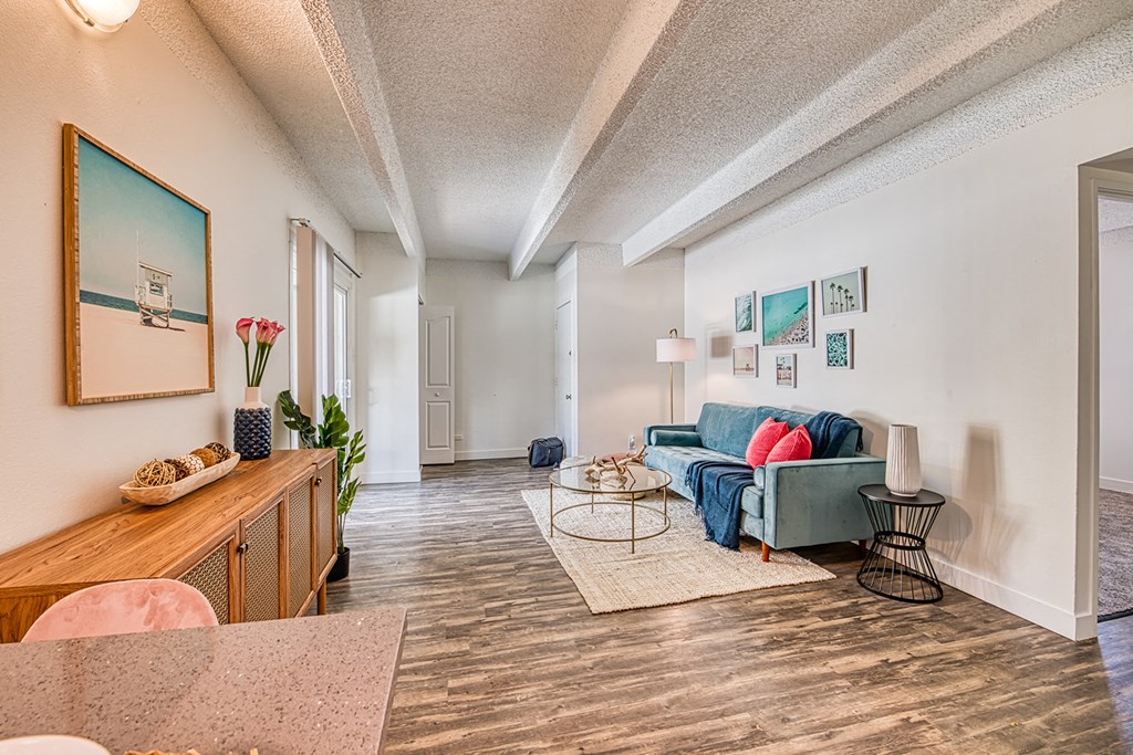 a living room with white walls and a wooden floor