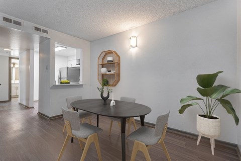 A dining room with a round table and chairs.