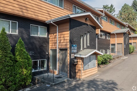 A building with a brown and black exterior and a sign that reads "2412 788".