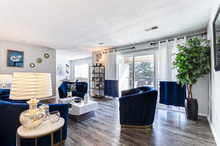 a living room with blue couches and a white coffee table