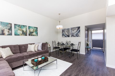 a living room and dining room with a couch and a table