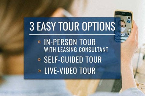 A person holding a phone with a video call on the screen and text about tour options.