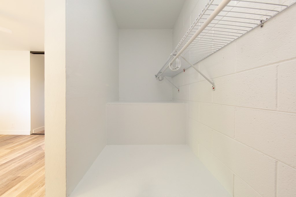 a room with a white floor and white walls and a white rack on the wall