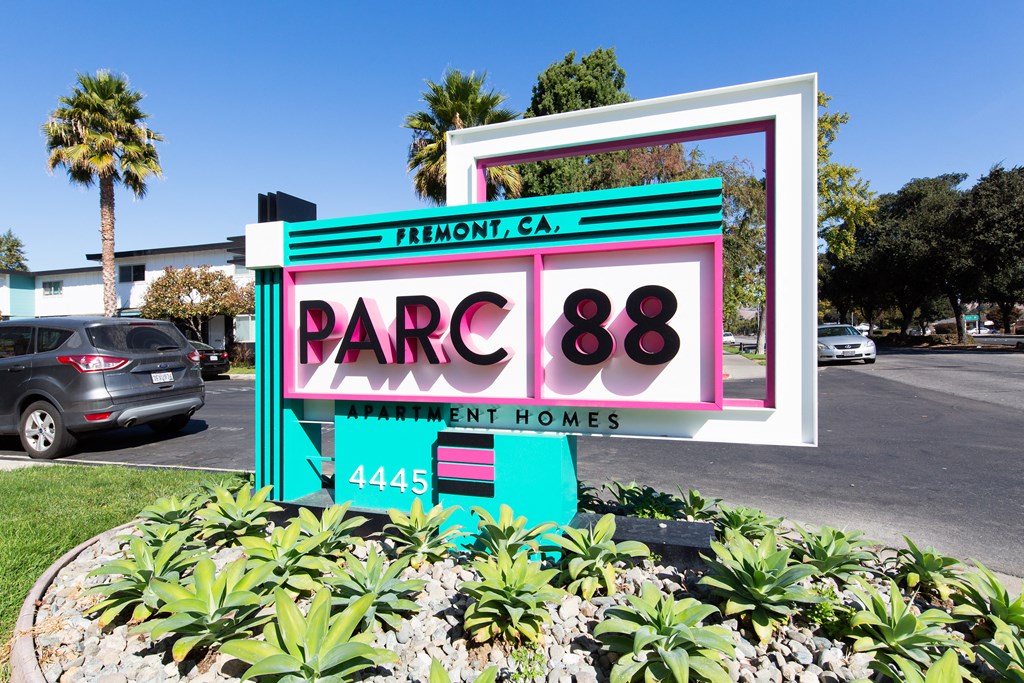 a sign in front of a parking lot