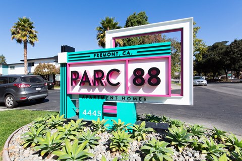 a sign in front of a parking lot