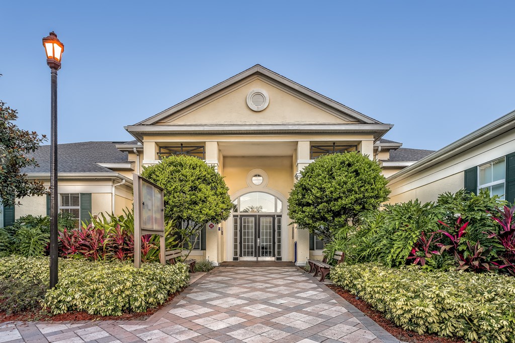 a house with a stone walkway and a lamp post in front of it