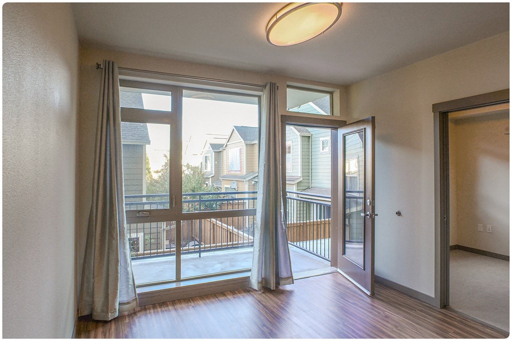 a living room with sliding glass doors and a balcony