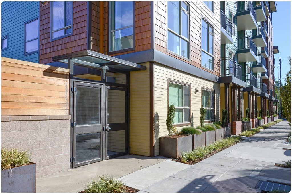 a row of apartment buildings on a city street