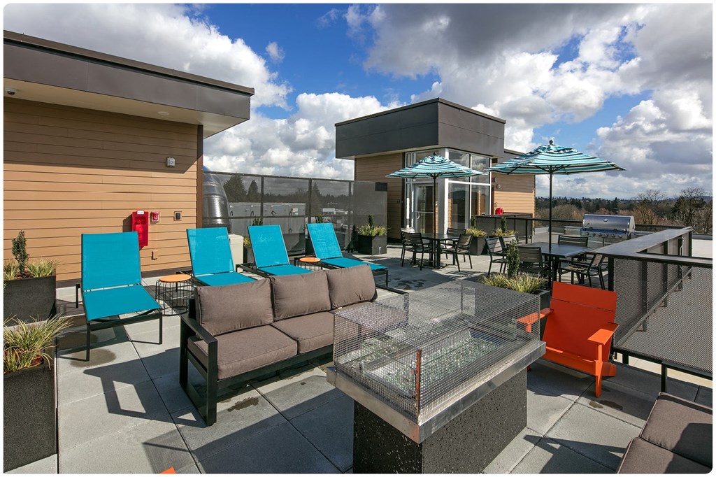 a patio with blue chairs and orange chairs and umbrellas