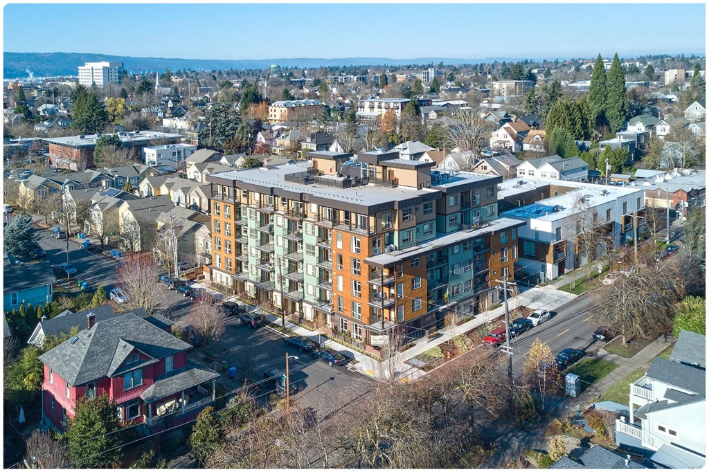 an aerial view of a large brick building with a grey roof