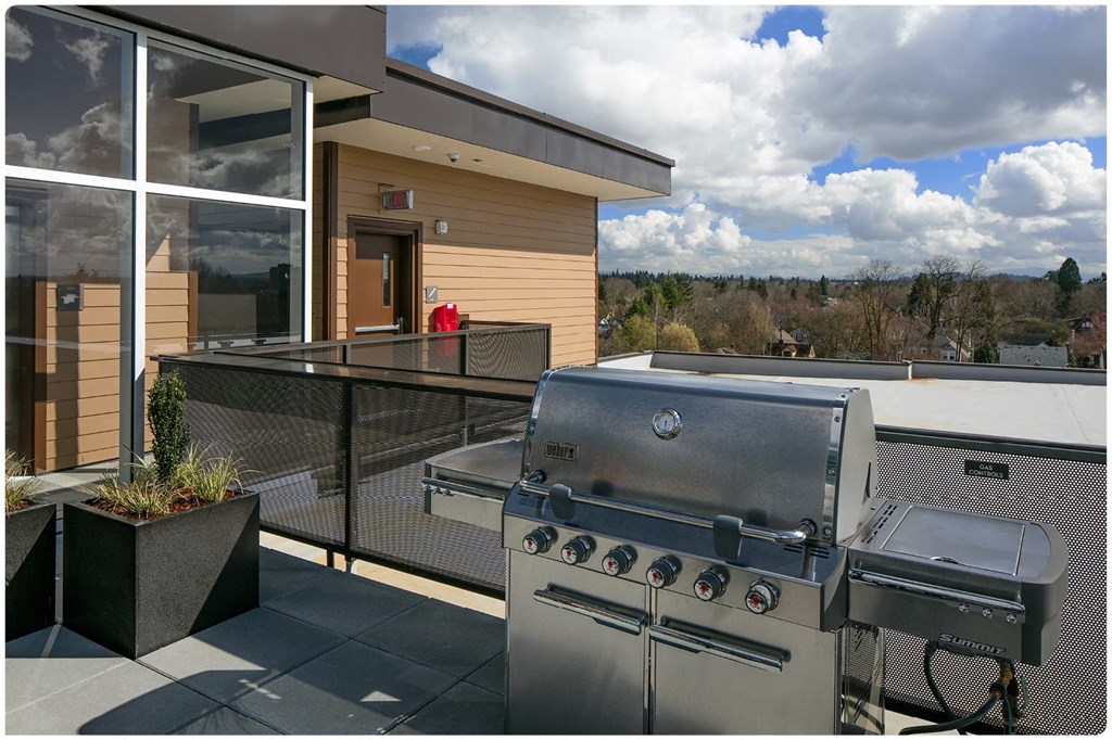 a stainless steel barbecue on the patio of a home
