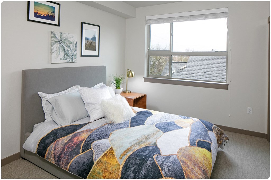 a bedroom with a bed and a window