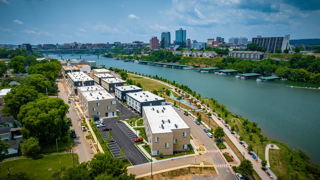 a view from the top of a building of a city with a river in the background