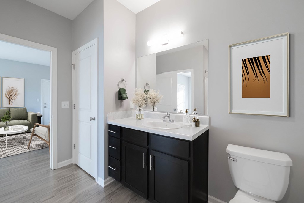 A bathroom with a white toilet and a white sink.