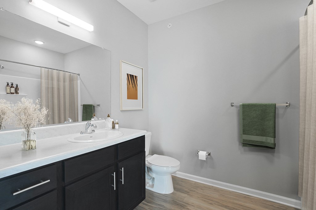 A bathroom with a white toilet and a white sink.