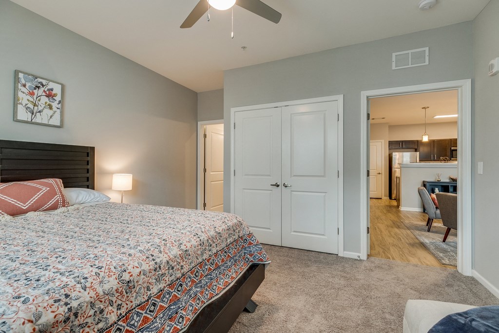 a bedroom with a large bed and a ceiling fan