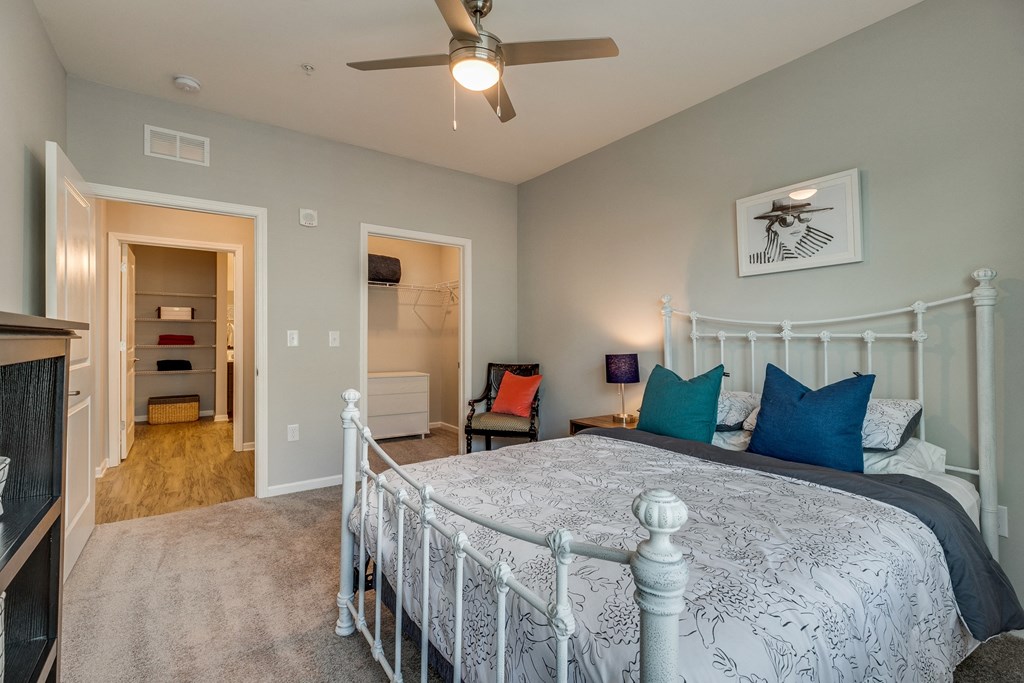 a bedroom with a bed and a ceiling fan