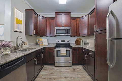 a kitchen with stainless steel appliances and wood cabinets