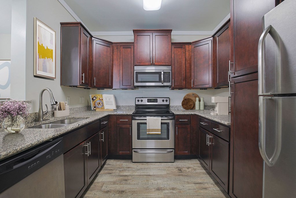 a kitchen with stainless steel appliances and wooden cabinets