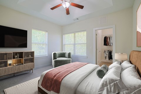 a bedroom with a large bed and a ceiling fan