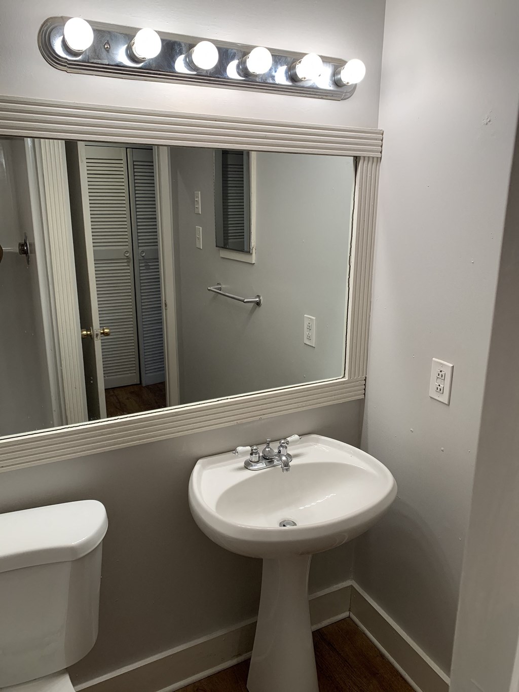 a bathroom with a sink and a mirror and a toilet