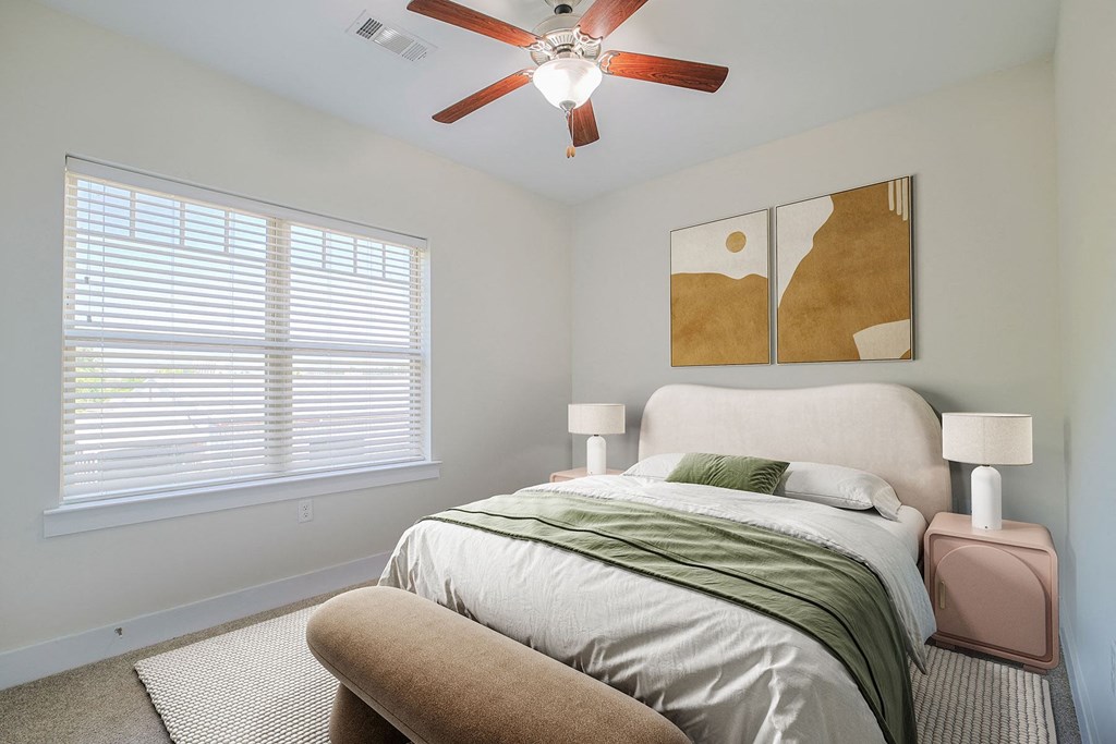 a bedroom with a bed and a ceiling fan