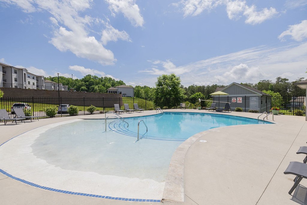 our apartments have a large pool with chairs and tables