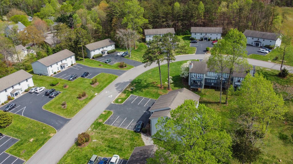 an aerial view of a neighborhood of houses with cars parked