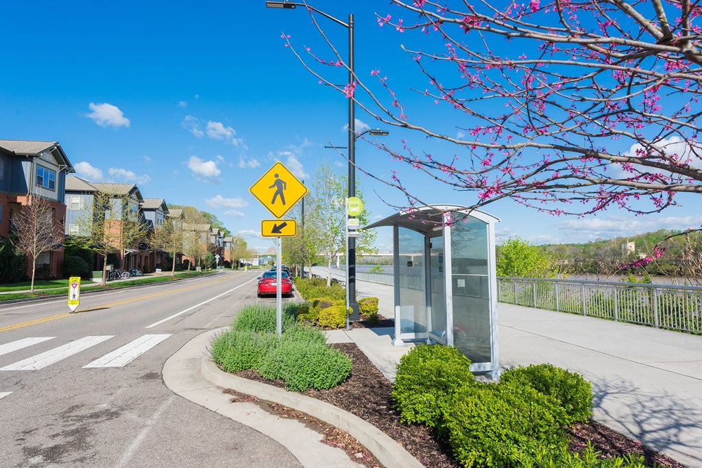 a street with a bus stop on the side of a road