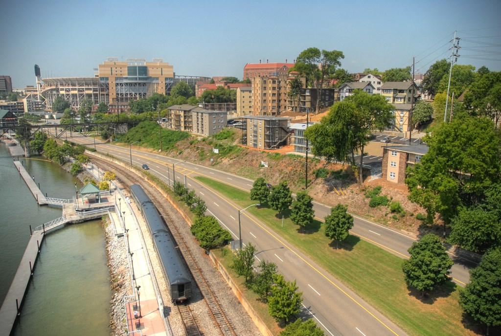 a view of a city with a river and a train