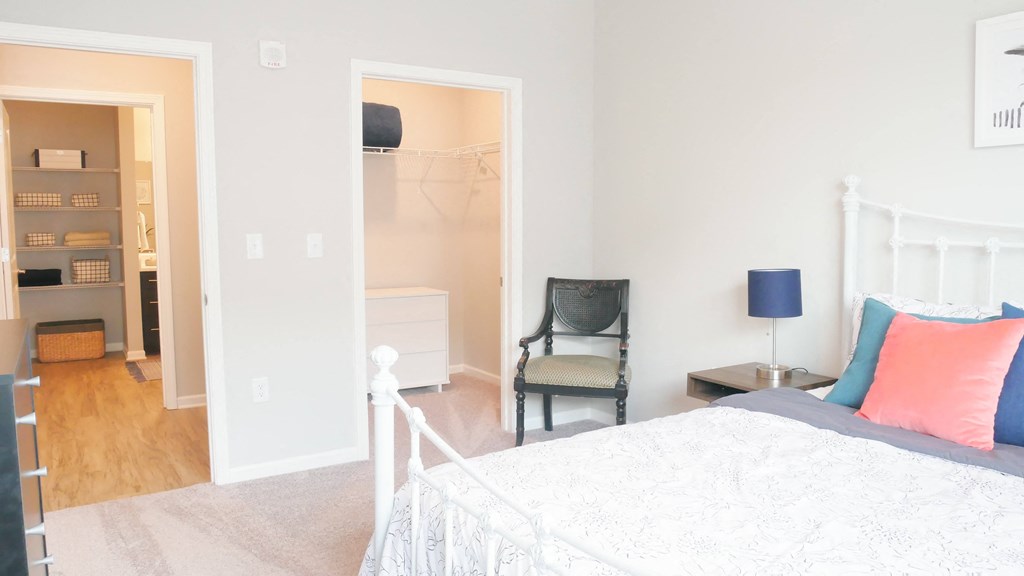 a bedroom with a bed and a door to a closet