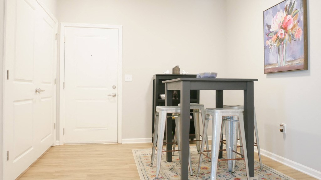 a group of stools and a table in a room with a door