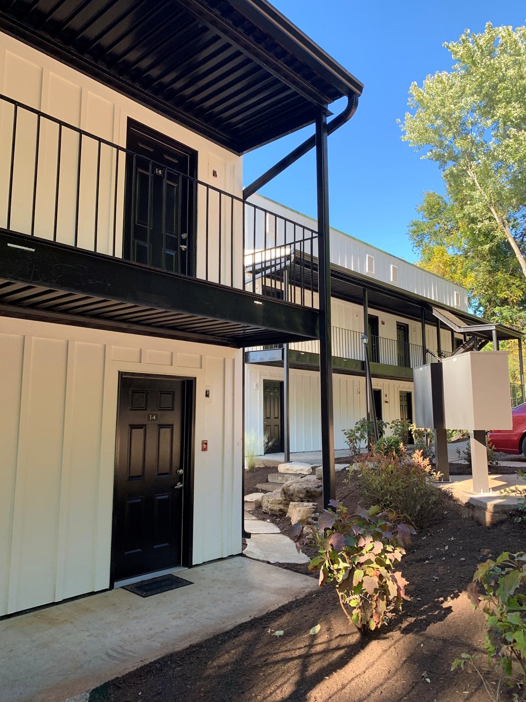 the outside of a building with a balcony and a sidewalk