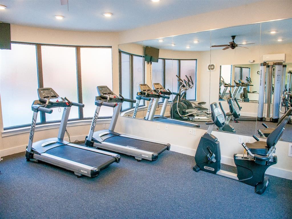 a gym with treadmills and other exercise equipment