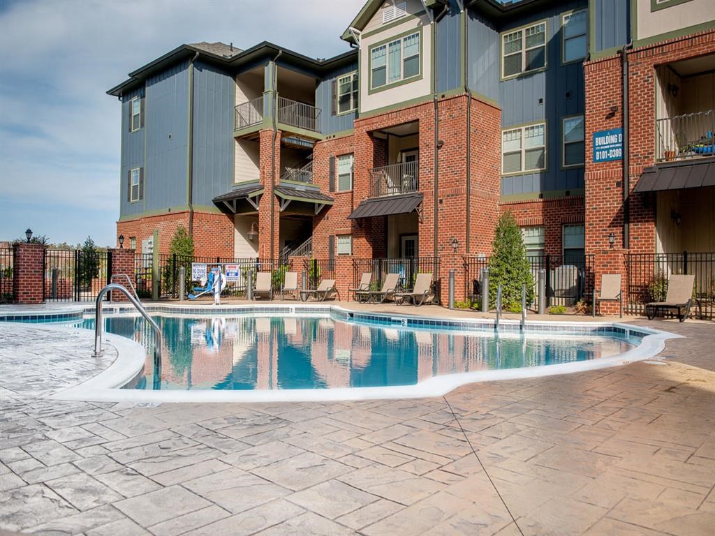 a swimming pool in front of an apartment building
